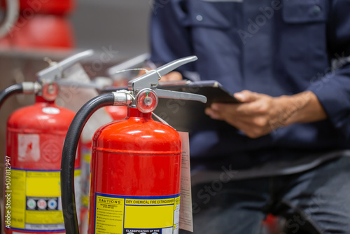 Engineer are checking and inspection a fire extinguishers tank in the fire control room for safety training and fire prevention.