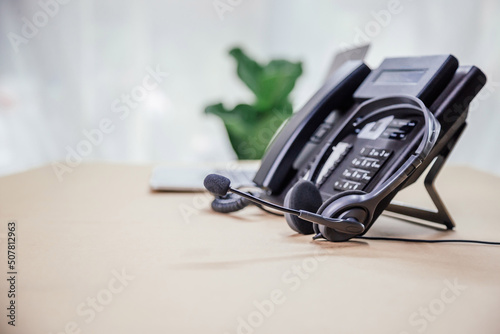 Communication support, call center and customer service help desk. telephone devices with VOIP headset in office.Customer service support (call center) concept.