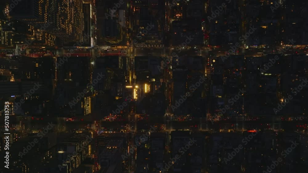 Aerial birds eye overhead top down panning view of building blocks at night. Fly above town development. Manhattan, New York City, USA Aerial birds eye overhead top down panning view of building blocks at night. Fly above town development. Manhattan, New York City, USA