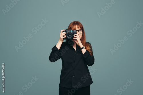 Professional photographer taking a picture in a studio photo