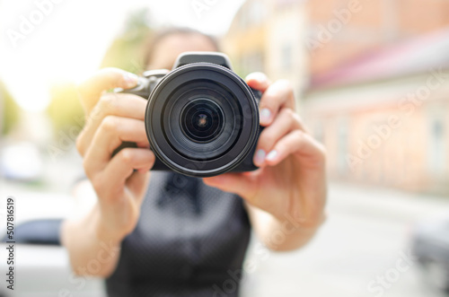 The photographer takes pictures on the street, close-up.