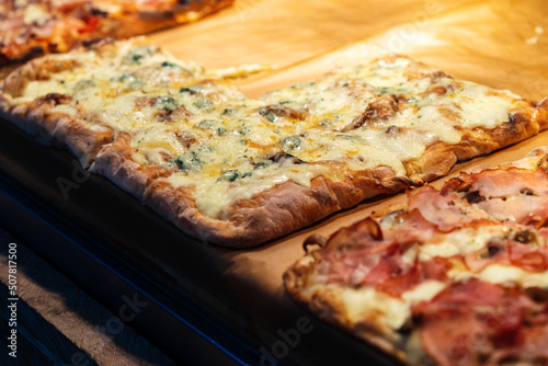 Photography Pizza pieces to go on a stall in pizzeria