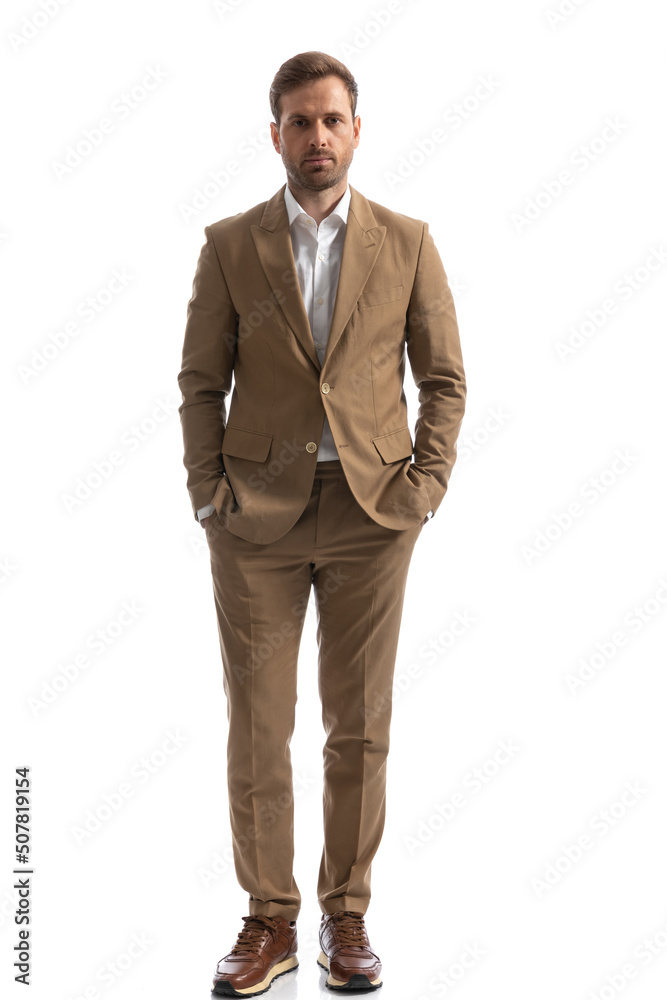 handsome businessman standing with his hands in pockets