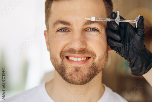 Man at beauty salon making injections