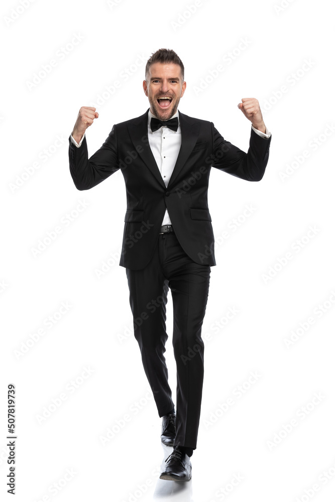 businessman celebrating the victory with his arms up businessman celebrating the victory with his arms up