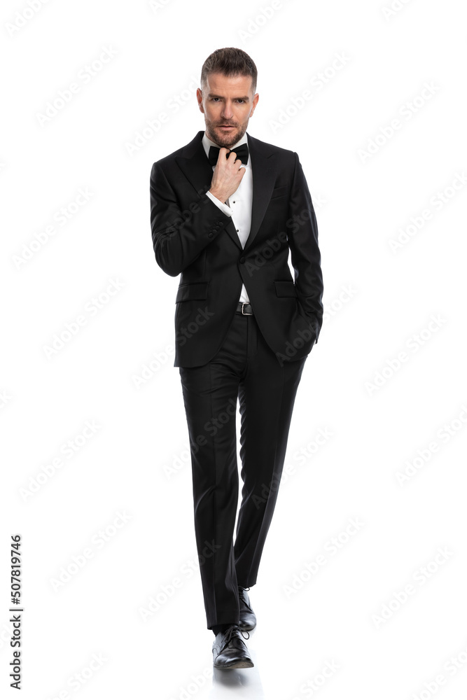 businessman walking with a tough look on his face