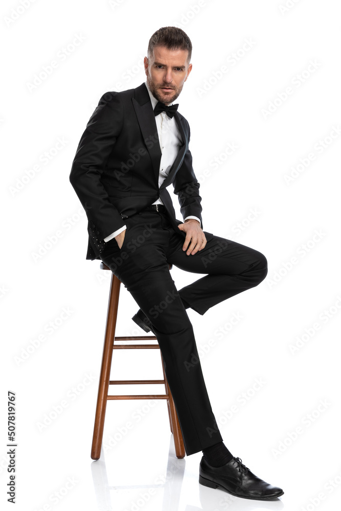 sexy businessman leaning on a chair, with attitude sexy businessman leaning on a chair, with attitude