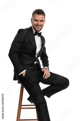 businessman sitting on a chair with one hand in pocket