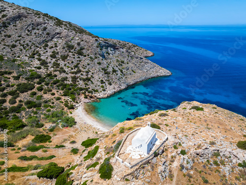 Fototapeta Naklejka Na Ścianę i Meble -  Aerial view of the small beach of Armeas next to Galissas with the picturesque church of Agios Pakos, Syros island, Cyclades, Greece