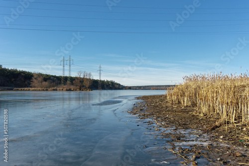 Blue lake with reeds along the shore