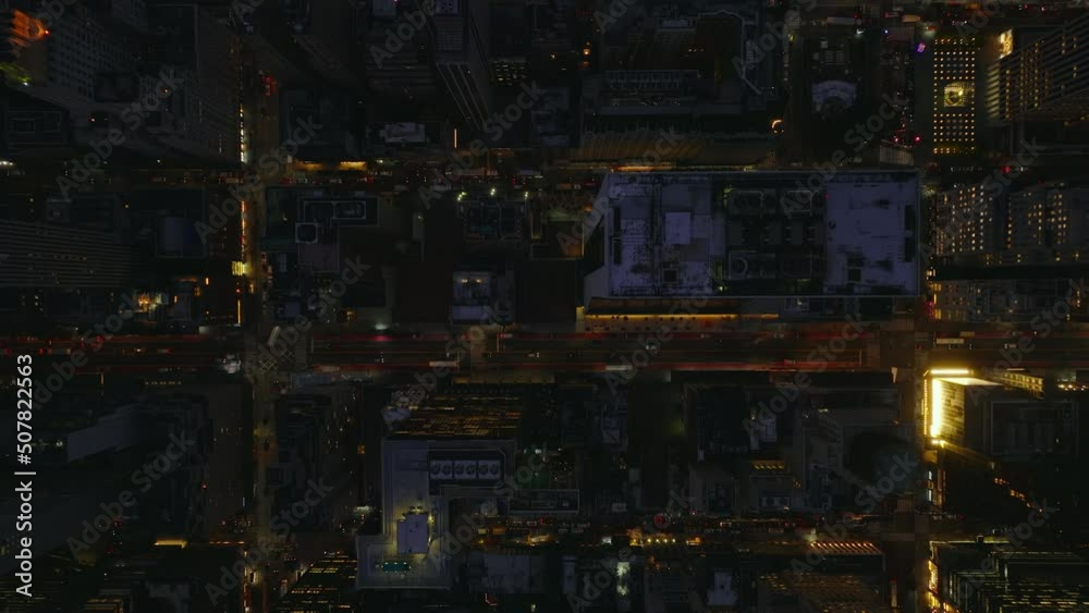 Aerial birds eye overhead top down panning view of evening city. Fly above illuminated streets and blocks of high rise buildings. Manhattan, New York City, USA Aerial birds eye overhead top down panning view of evening city. Fly above illuminated streets and blocks of high rise buildings. Manhattan, New York City, USA