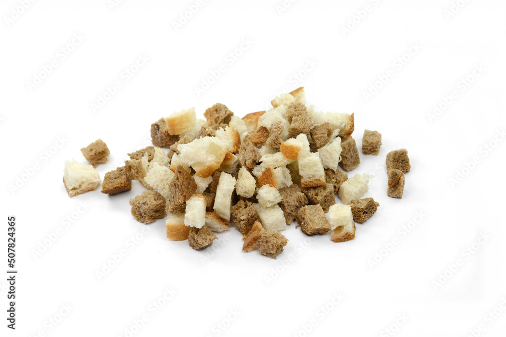 Bread croutons on a white background. Scattered pile of homemade rye bread croutons isolated on white background top view. Crispy bread cubes, dry rye crumbs, rusks, crouoton or brown roasted crackers Bread croutons on a white background. Scattered pile of homemade rye bread croutons isolated on white background top view. Crispy bread cubes, dry rye crumbs, rusks, crouoton or brown roasted crackers