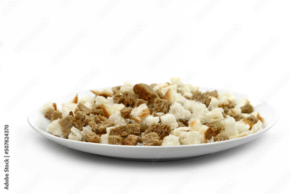 Bread croutons on a white background. Scattered pile of homemade rye bread croutons isolated on white background top view. Crispy bread cubes, dry rye crumbs, rusks, crouoton or brown roasted crackers Bread croutons on a white background. Scattered pile of homemade rye bread croutons isolated on white background top view. Crispy bread cubes, dry rye crumbs, rusks, crouoton or brown roasted crackers