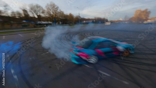Adrenaline sport scene drone chase drifting car in carpark. Dynamic aerial photo