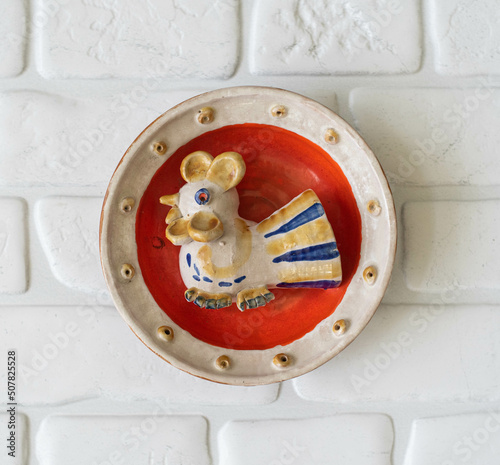 Mid-century modern pottery - red wall plate with a chicken figurine photo