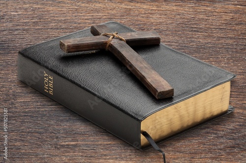 Religious wooden cross on the pages of a bible