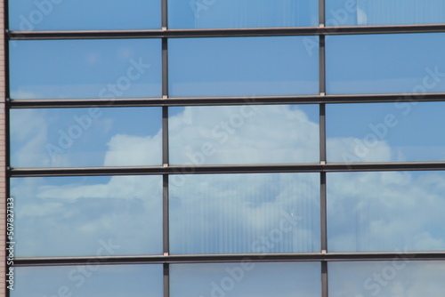 Office building windows with clouds mirror.