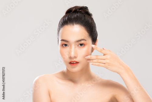 Beautiful Asian young woman touching soft cheek smile with clean and fresh skin Happiness and cheerful with positive emotional isolated on white background. Self care of Beauty and Cosmetics Concept