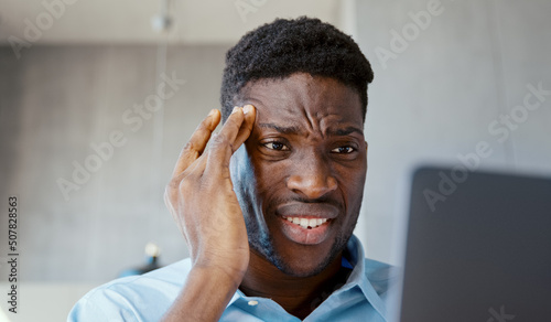 Serious businessman talking on the phone and working in computer