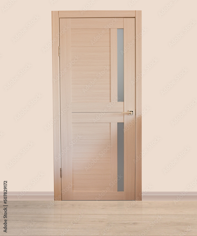An empty room with a modern wooden door. The walls are covered with light pastel wallpaper. Minimalistic light interior. The concept of buying an apartment An empty room with a modern wooden door. The walls are covered with light pastel wallpaper. Minimalistic light interior. The concept of buying an apartment