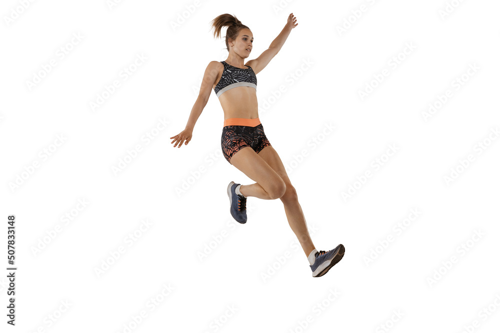 Long jump technique. Studio shot of professional female athlete in sports uniform jumping isolated on white background. Concept of sport, action, motion, speed.