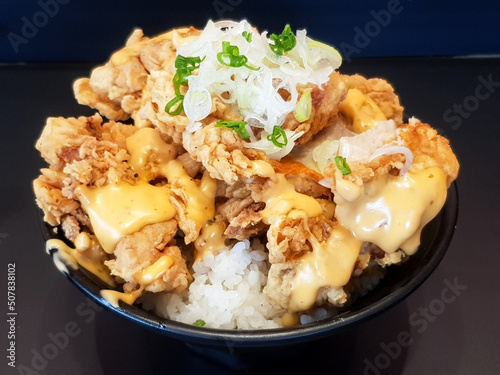 Fried chicken with mayonnaise sauce and rice on dish background