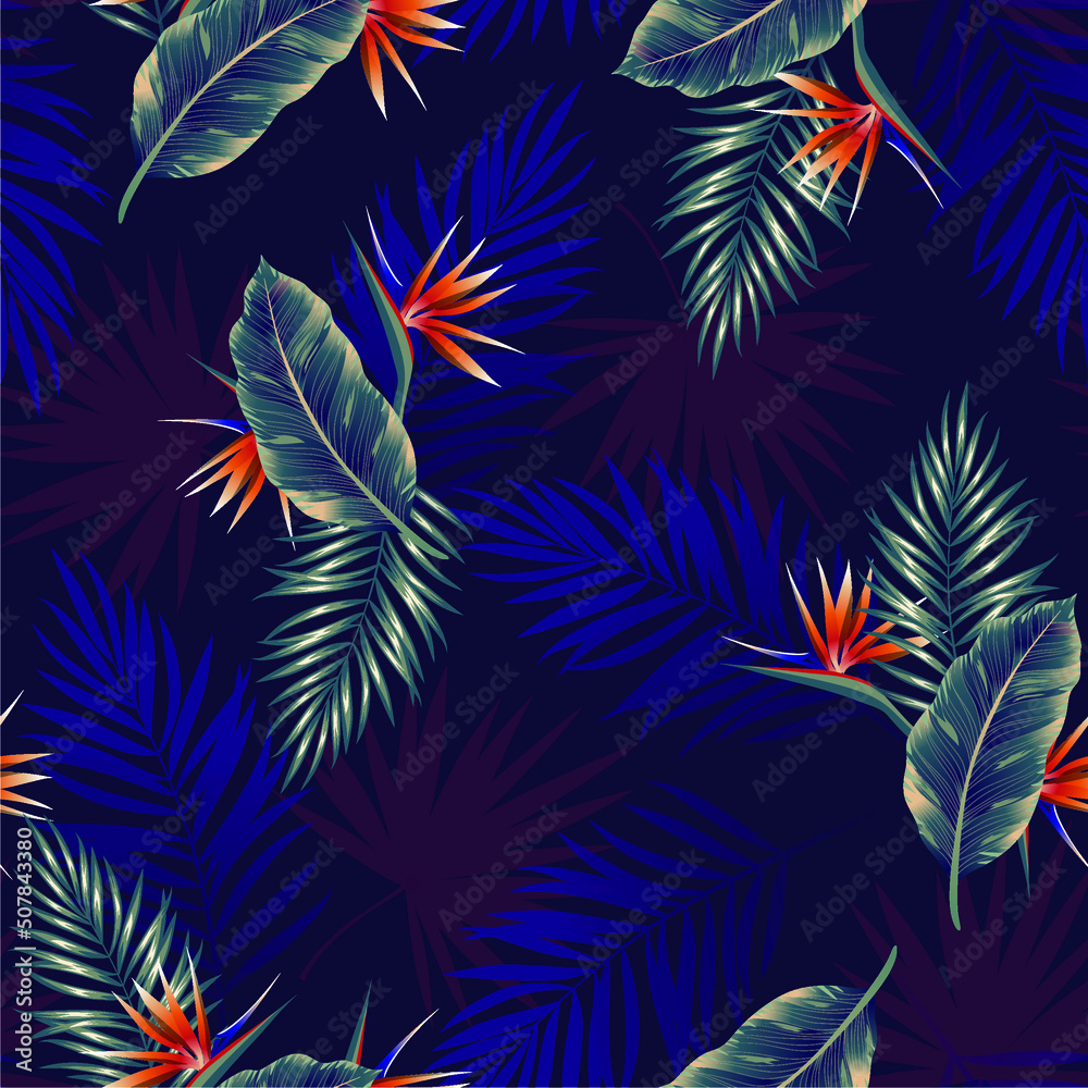 Seamless pattern of tropical dark leaves of palm trees and flowers bird of paradise (strelitzia) on a blue background. Design for paper, cover, fabric, interior decor and other users.