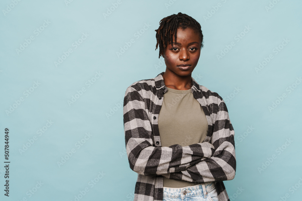 African american woman wearing plaid shirt standing with arms folded African american woman wearing plaid shirt standing with arms folded