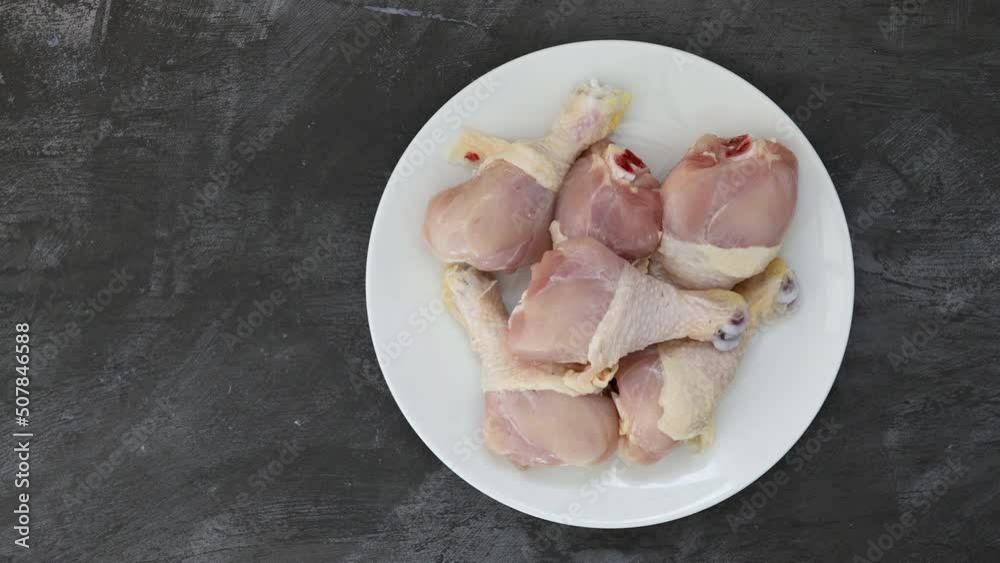 Serving a Plate of Raw Chicken Drumsticks with Room for Copy Serving a Plate of Raw Chicken Drumsticks with Room for Copy