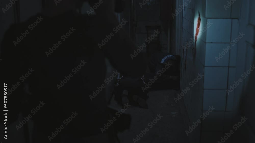 Silhouette of soldier with shaved head holding flashlight, inspecting dark and creepy abandoned building, spotting two zombies feeding on victim, then following military person Silhouette of soldier with shaved head holding flashlight, inspecting dark and creepy abandoned building, spotting two zombies feeding on victim, then following military person