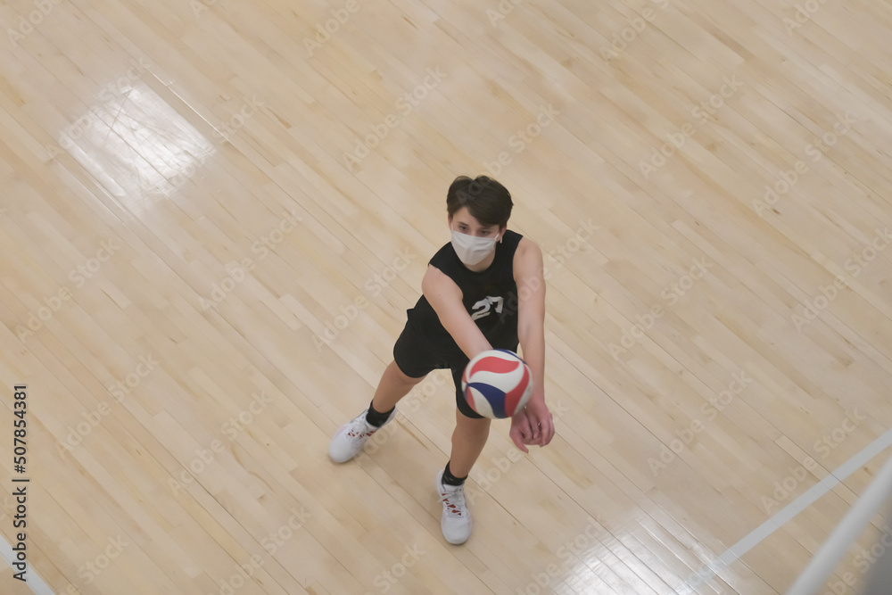 Fototapeta premium Masked volleyball player passing the ball