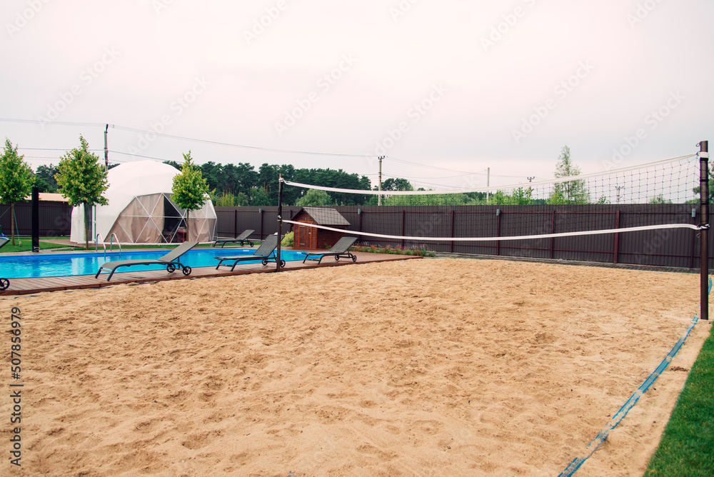 sand volleyball court near the pool. Recreation and sports area. Stock Photo Adobe Stock