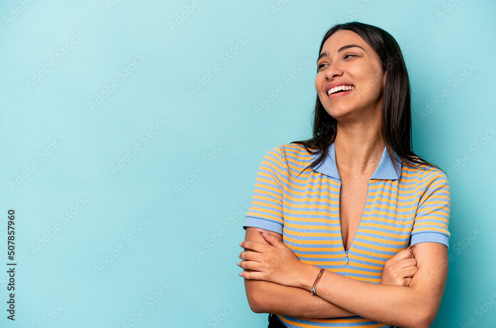 Young hispanic woman isolated on blue background smiling confident with crossed arms. Young hispanic woman isolated on blue background smiling confident with crossed arms.