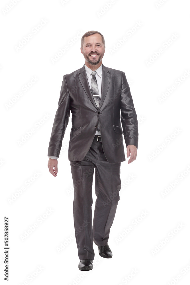 in full growth. confident business man striding forward. in full growth. confident business man striding forward.
