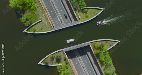 Small boat passing over Aquaduct Veluwemeer water bridge.
