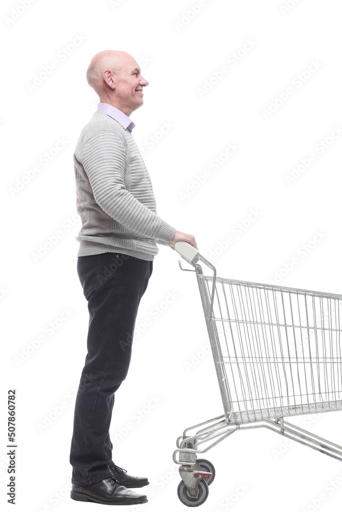in full growth. a happy man with a shopping cart. in full growth. a happy man with a shopping cart.