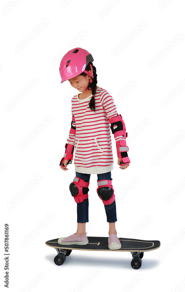 Portrait of Asian little girl skateboarder with wearing safety and protective equipment stand on skateboard isolated on white background. Image with Clipping path.