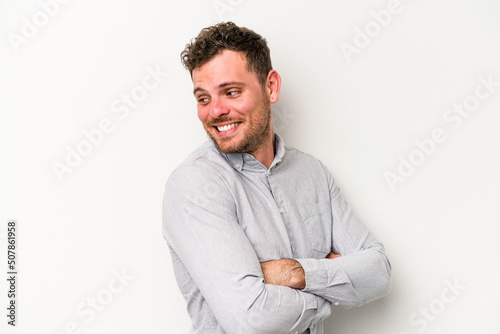 Young caucasian man isolated on white background laughing and having fun. © Asier