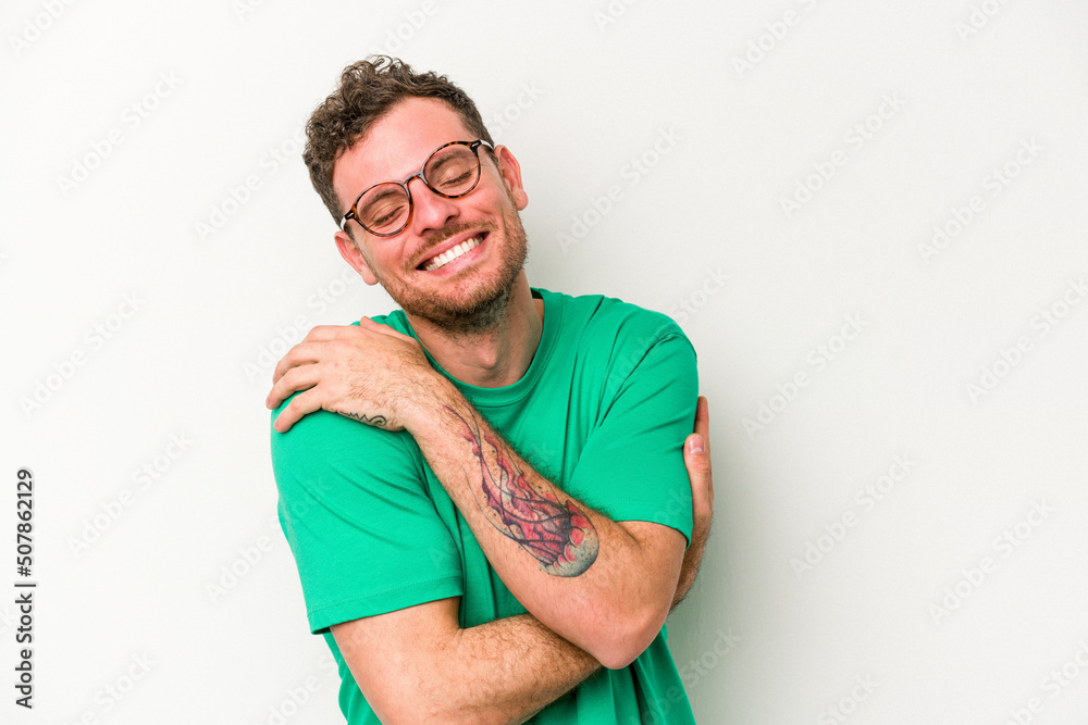 Obraz premium Young caucasian man isolated on white background laughing and having fun.