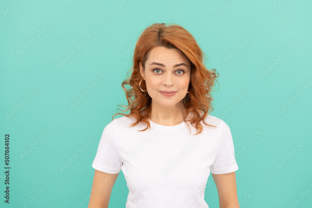 cheerful redhead woman with curly hair on blue background cheerful redhead woman with curly hair on blue background