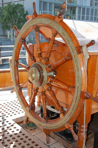 Vintage wooden ship's steering wheel, steering wheel on a yacht or ship close-up