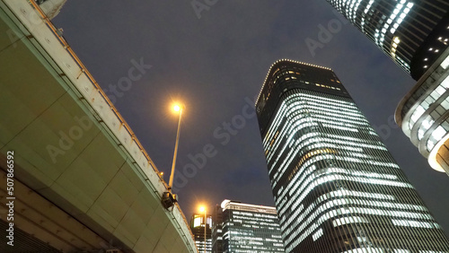 Photography Low or uprisen angle view of modern skyscraper tower building in the night that