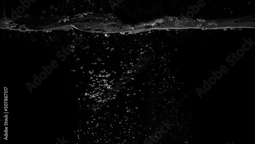 Water bubbles floating on black background which represent refreshing of refreshment from soda or carbonated drink and power of liquid that splashing or fizzing with blowing and streaming by air pump.