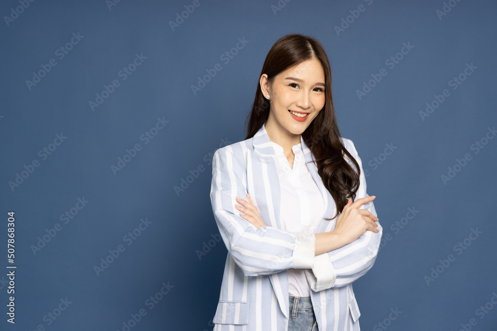 Portrait of successful business asian women in suit with arms crossed and smile isolated over blue background Portrait of successful business asian women in suit with arms crossed and smile isolated over blue background