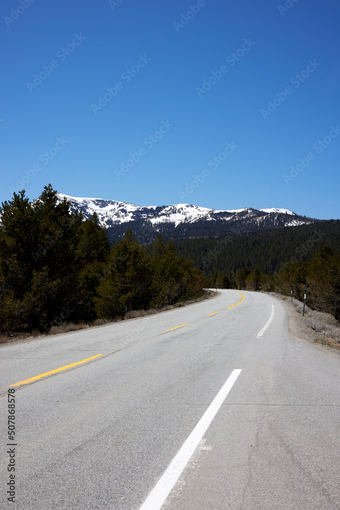 American Road with snow coverd mountains in the back American Road with snow coverd mountains in the back