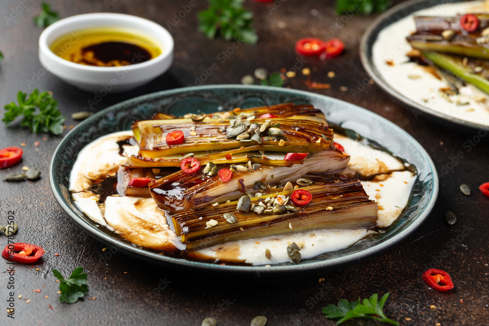 Sweet and sour braised leeks over whipped feta cheese, vegetarian vegan summer Asian style food concept Sweet and sour braised leeks over whipped feta cheese, vegetarian vegan summer Asian style food concept