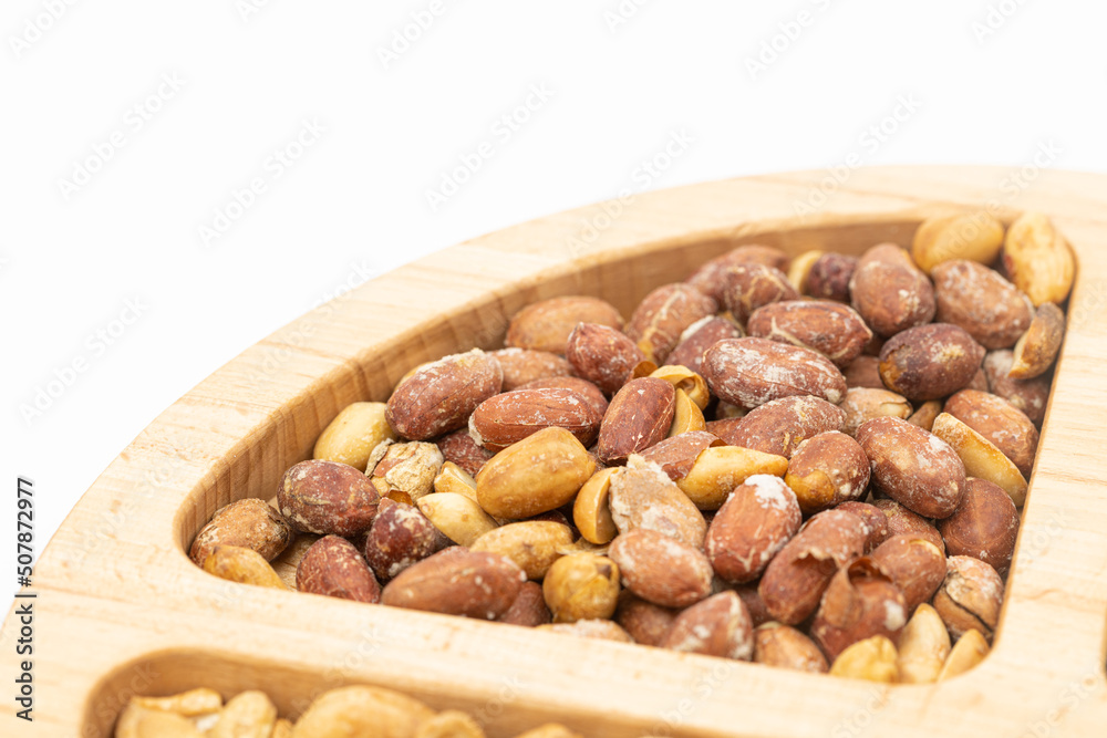 Peanuts cashew sunflower seeds and chickpea in the wooden bowl above white background Peanuts cashew sunflower seeds and chickpea in the wooden bowl above white background