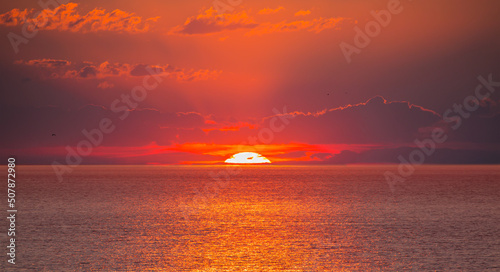 Fototapeta Naklejka Na Ścianę i Meble -  Amazing red sunset with yellow sun over the sea - Alanya, Turkey