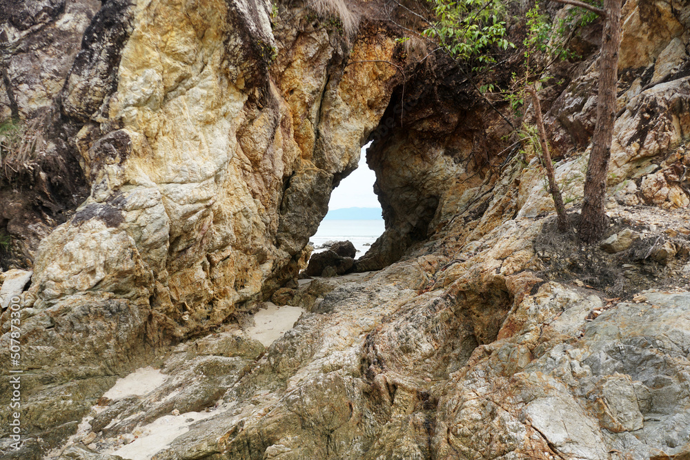 Fototapeta premium Pierced stone or hole in a massive quartzite rocky cliff.