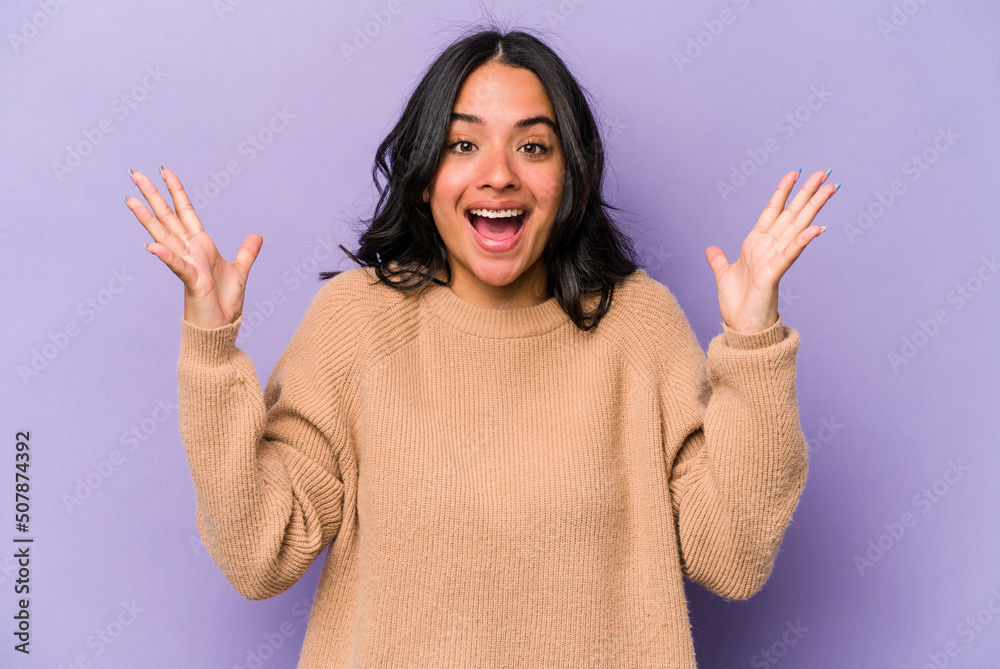 Young hispanic woman isolated on purple background receiving a pleasant surprise, excited and raising hands. Young hispanic woman isolated on purple background receiving a pleasant surprise, excited and raising hands.